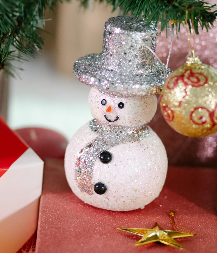  a really cute fake snowman under a tree