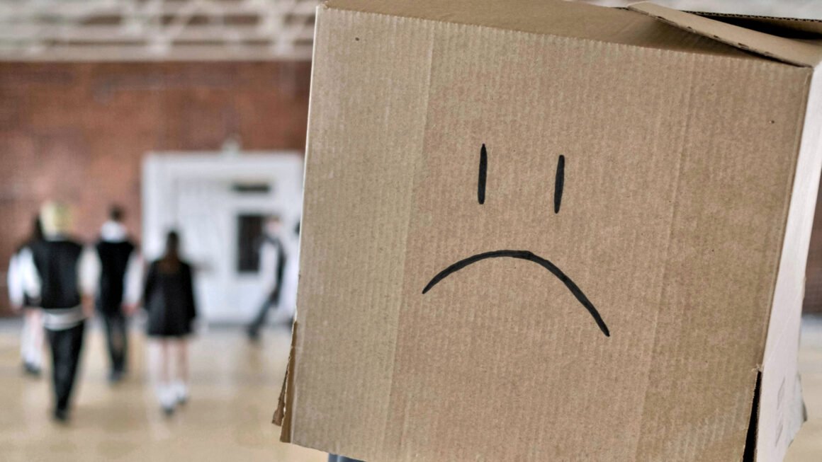 sad face hiding under a paper bag